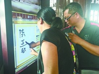 圖為一對游客夫妻在“涂鴉”。(記者謝東波攝)